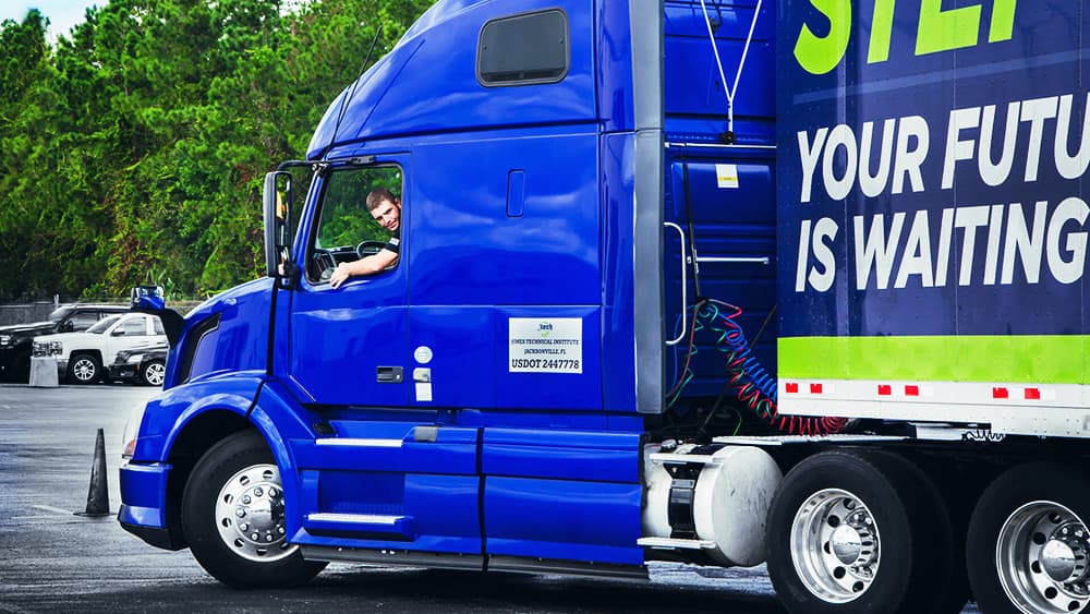 A Commercial Truck Driving student learning to back the J-Tech truck up in the driving lot.