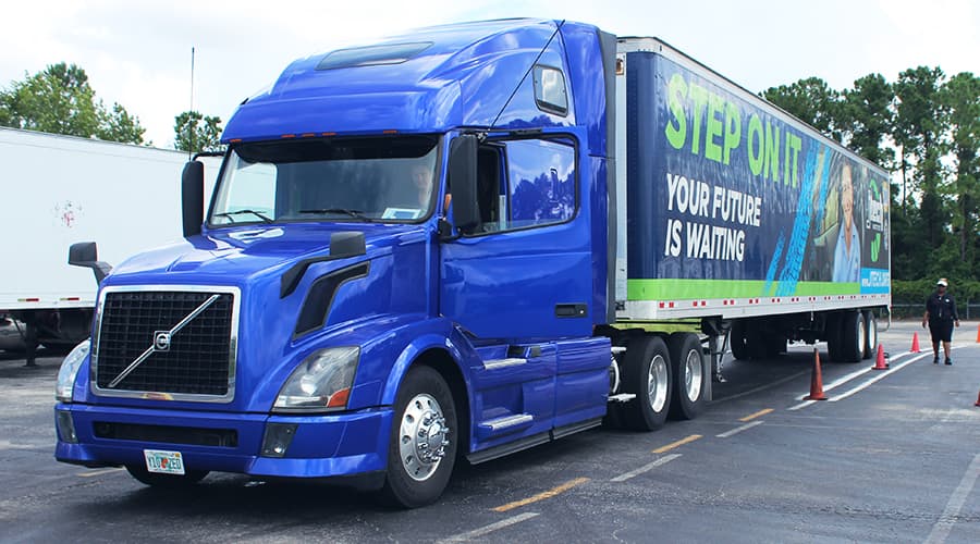 J-Tech Truck Driving student parking the J-Tech-branded Volvo semi truck alongside an instructor.