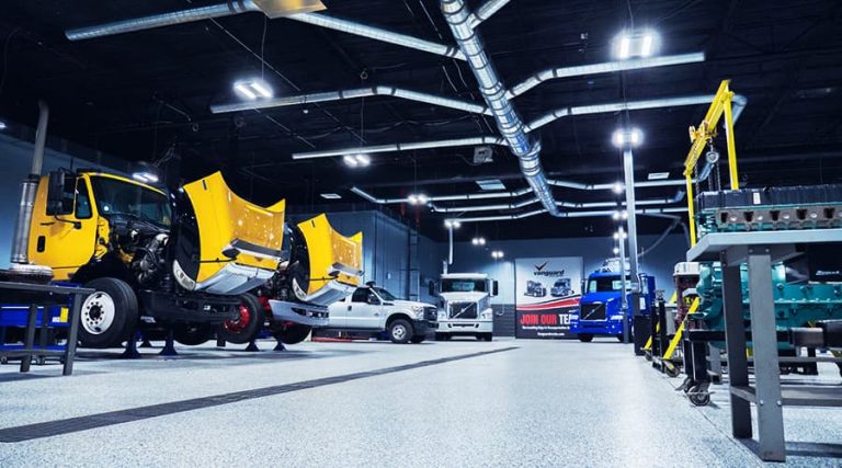 Photo of the J-Tech Diesel Technology lab, featuring multiple tractors, engines, and plenty of space to work.