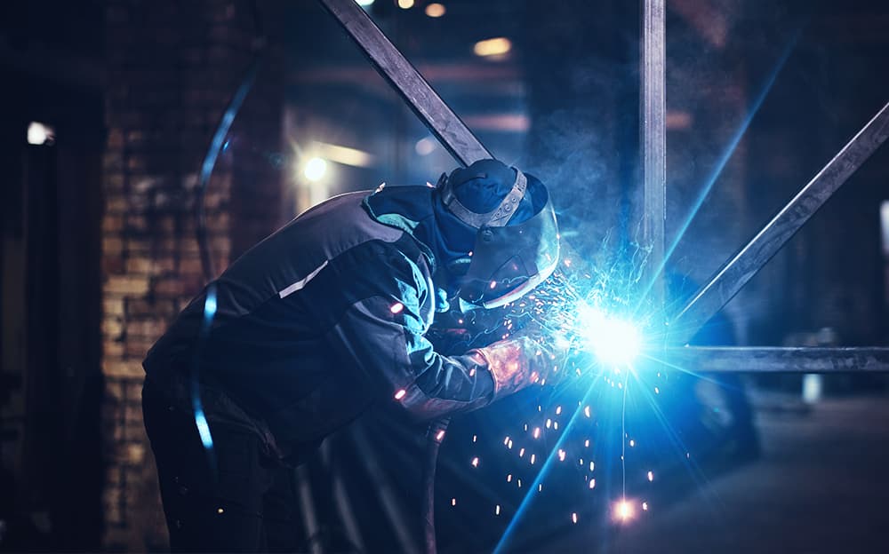 Welder at work in a metal factory.