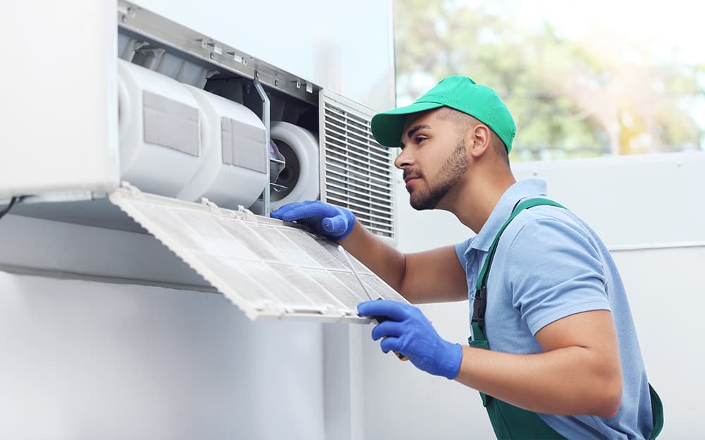 HVAC technician inspecting a residential AC unit