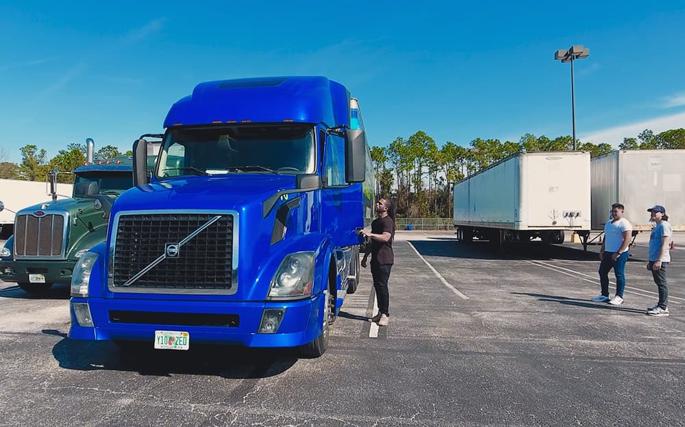 J-Tech Commercial Truck Driving student getting into the cab of the J-Tech testing truck