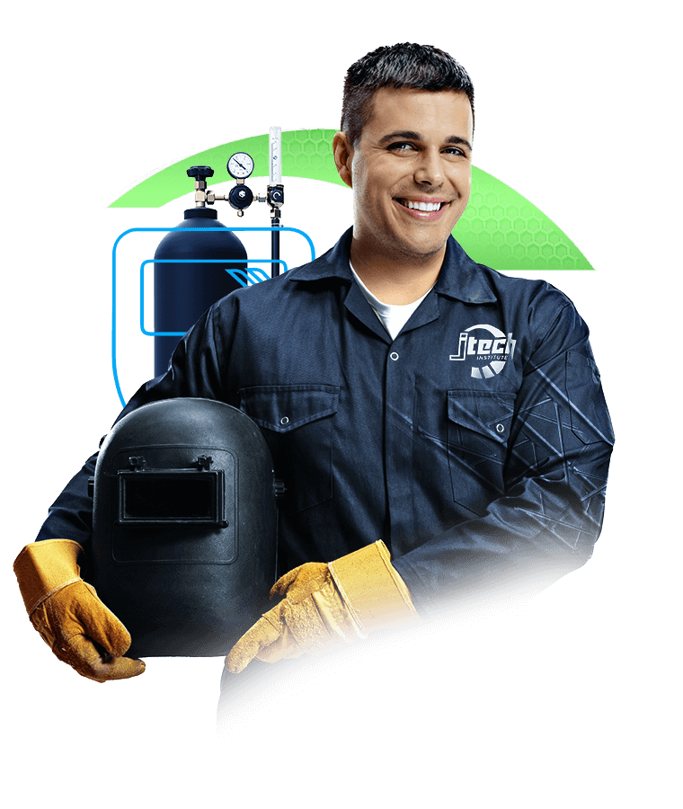 J-Tech Welding & Fabrication Technology student, holding a welding helmet in front of gas tanks