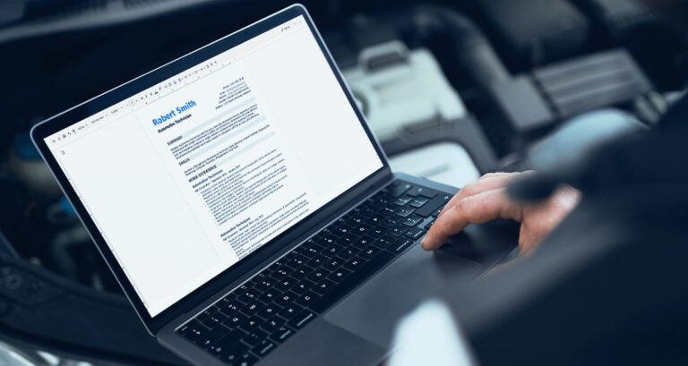 A Man Typing on His Computer and Creating a Resume.
