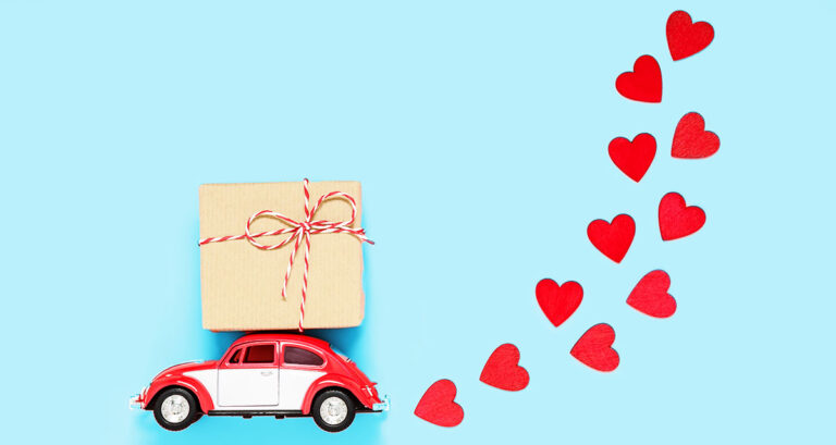 A Car with a Package on its Roof for Valentine's Day.