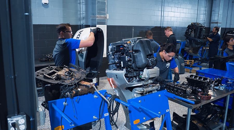 J-Tech Marine & RV Technology students working hands-on with boat engines in the new lab.